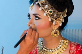 Wedding makeup artist making a make up for bride